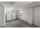 Unfinished basement with two refrigerators, concrete flooring and shelving at 6918 E Long Ave, Centennial, CO 80112
