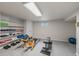 Basement area with workout equipment, shelving for storage, and carpet flooring at 6918 E Long Ave, Centennial, CO 80112