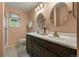 Bathroom with a double sink vanity, updated fixtures, and modern tile flooring at 6918 E Long Ave, Centennial, CO 80112