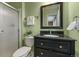 Well-maintained bathroom featuring a sleek black vanity, updated fixtures, and a glass-enclosed shower stall at 6918 E Long Ave, Centennial, CO 80112