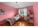 Charming bedroom featuring hardwood floors, a large window, and a cozy bed, perfect for a room at 6918 E Long Ave, Centennial, CO 80112