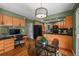 Dining area with modern lighting fixture, seamlessly connected to the kitchen and workspace at 6918 E Long Ave, Centennial, CO 80112