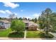 Traditional two-story home with brick and siding exterior, mature trees, and well-manicured front lawn at 6918 E Long Ave, Centennial, CO 80112