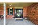 Inviting covered front porch with brick accents and stylish outdoor seating at 6918 E Long Ave, Centennial, CO 80112