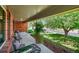 Relaxing covered front porch with comfortable seating and views of the landscaped yard at 6918 E Long Ave, Centennial, CO 80112