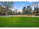 Large community playground with climbing structure, swings, slide, and shade structures with expansive lawn at 6918 E Long Ave, Centennial, CO 80112