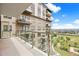 A balcony with glass railing overlooking a city view at 7600 Landmark Way # 1215, Greenwood Village, CO 80111