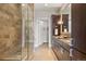 Stylish bathroom showcasing a glass enclosed shower and double vanity with a granite countertop at 7600 Landmark Way # 1215, Greenwood Village, CO 80111