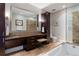 Spacious bathroom with dual sinks, granite countertops, a glass-enclosed shower, and a soaking tub at 7600 Landmark Way # 1215, Greenwood Village, CO 80111