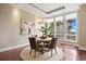 Bright dining area with hardwood floors, area rug, elegant lighting, and large windows with city views at 7600 Landmark Way # 1215, Greenwood Village, CO 80111