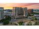 Aerial view of a modern high-rise apartment building with beautiful sunset sky in the background at 7600 Landmark Way # 1215, Greenwood Village, CO 80111