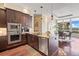 Bright kitchen featuring wood floors, stainless steel appliances, granite countertops, and eat-in breakfast area at 7600 Landmark Way # 1215, Greenwood Village, CO 80111