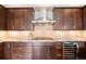 This well-appointed kitchen boasts modern appliances, gas range, granite countertops and dark-stained cabinets at 7600 Landmark Way # 1215, Greenwood Village, CO 80111
