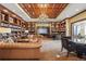 Well-appointed library with bookshelves, a chandelier, and seating area at 7600 Landmark Way # 1215, Greenwood Village, CO 80111