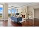 Bright living room with a fireplace, modern furniture, hardwood floors, and city views from bright windows at 7600 Landmark Way # 1215, Greenwood Village, CO 80111