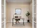 This bright home office features french doors, a modern desk and chair, and a city-themed art print at 7600 Landmark Way # 1215, Greenwood Village, CO 80111