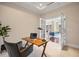 Bright office with desk setup, French doors, and view into the living room at 7600 Landmark Way # 1215, Greenwood Village, CO 80111