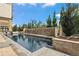 Resort-style pool features a waterfall feature and is surrounded by lush landscaping at 7600 Landmark Way # 1215, Greenwood Village, CO 80111