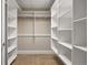 Bright walk-in closet featuring custom shelving, ample storage, and carpet floors at 7600 Landmark Way # 1215, Greenwood Village, CO 80111