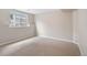 Carpeted basement bedroom with natural light and view of the outside at 2304 S Holly St # A, Denver, CO 80222
