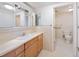 Well-maintained bathroom with tiled floor, vanity, and accessible toilet at 2304 S Holly St # A, Denver, CO 80222