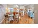 Bright, open floor plan with dining area featuring a glass table and hardwood floors at 2304 S Holly St # A, Denver, CO 80222
