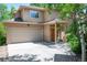 Inviting home with a covered porch, two-car garage, and lush landscaping for curb appeal at 2304 S Holly St # A, Denver, CO 80222