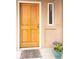 Inviting front door with decorative mat and colorful potted flowers at 2304 S Holly St # A, Denver, CO 80222