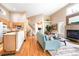 Bright living room features hardwood floors, fireplace, and a vaulted ceiling at 2304 S Holly St # A, Denver, CO 80222