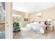 Inviting main bedroom with a plush rug, comfortable armchair, and balcony access at 2304 S Holly St # A, Denver, CO 80222