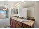 Bathroom features a double vanity with granite countertop and access to the bedroom at 7662 Bristolwood Dr, Castle Pines, CO 80108