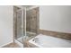 Modern bathroom showcasing a glass shower enclosure and a luxurious soaking tub at 7662 Bristolwood Dr, Castle Pines, CO 80108