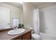 Bathroom featuring a single sink vanity, neutral walls and floors and a tub with shower at 7662 Bristolwood Dr, Castle Pines, CO 80108