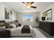 Inviting bedroom with king bed, soft lighting, window views, and modern wall decor at 7662 Bristolwood Dr, Castle Pines, CO 80108