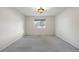 Neutral bedroom with a large window that provides excellent natural light and a simple ceiling light fixture at 7662 Bristolwood Dr, Castle Pines, CO 80108