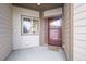 Inviting front entry with red door and small porch at 7662 Bristolwood Dr, Castle Pines, CO 80108