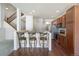 Kitchen featuring breakfast bar seating, stainless steel appliances, and beautiful wooden cabinetry at 7662 Bristolwood Dr, Castle Pines, CO 80108