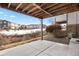 Concrete patio under a wooden deck, offering outdoor space at 7662 Bristolwood Dr, Castle Pines, CO 80108