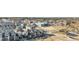 Community aerial view showcasing modern townhomes, surrounding city views, businesses, and landscaping at 10066 Belvedere Cir, Lone Tree, CO 80124