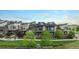 Aerial view of modern townhomes with solar panels, green spaces, and community walkways, showcasing energy efficiency at 10066 Belvedere Cir, Lone Tree, CO 80124
