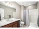 Bathroom features a shower with a shower curtain, a vanity and a large mirror at 10066 Belvedere Cir, Lone Tree, CO 80124