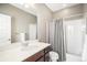 Bathroom features a shower with a shower curtain, a vanity and a large mirror at 10066 Belvedere Cir, Lone Tree, CO 80124