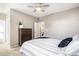 Neutral bedroom features a ceiling fan, a view of the entry and a wood dresser at 10066 Belvedere Cir, Lone Tree, CO 80124