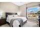 Bright bedroom features a large window and a plush queen size bed with soft carpet at 10066 Belvedere Cir, Lone Tree, CO 80124