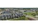 Expansive community aerial view showcasing modern townhomes with solar panels amidst parks, retail areas, and streets at 10066 Belvedere Cir, Lone Tree, CO 80124