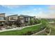 Beautiful view of modern townhomes with landscaping, green spaces, and walkways, offering a vibrant community at 10066 Belvedere Cir, Lone Tree, CO 80124