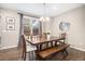 Classic dining area with wooden table, bench seating and modern light fixture at 10066 Belvedere Cir, Lone Tree, CO 80124