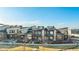 Aerial view of new townhomes, complete with modern architecture, solar panels, landscaping, and walkway at 10066 Belvedere Cir, Lone Tree, CO 80124