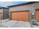 Spacious two-car garage with modern doors, exterior lighting, and side-mounted AC unit for enhanced convenience at 10066 Belvedere Cir, Lone Tree, CO 80124