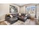 Comfortable living room with a large sectional sofa and plenty of natural light at 10066 Belvedere Cir, Lone Tree, CO 80124
